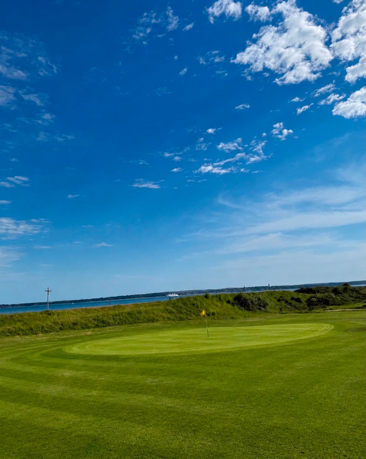 The routing's shared ground seen from tee height, flags on two greens in view