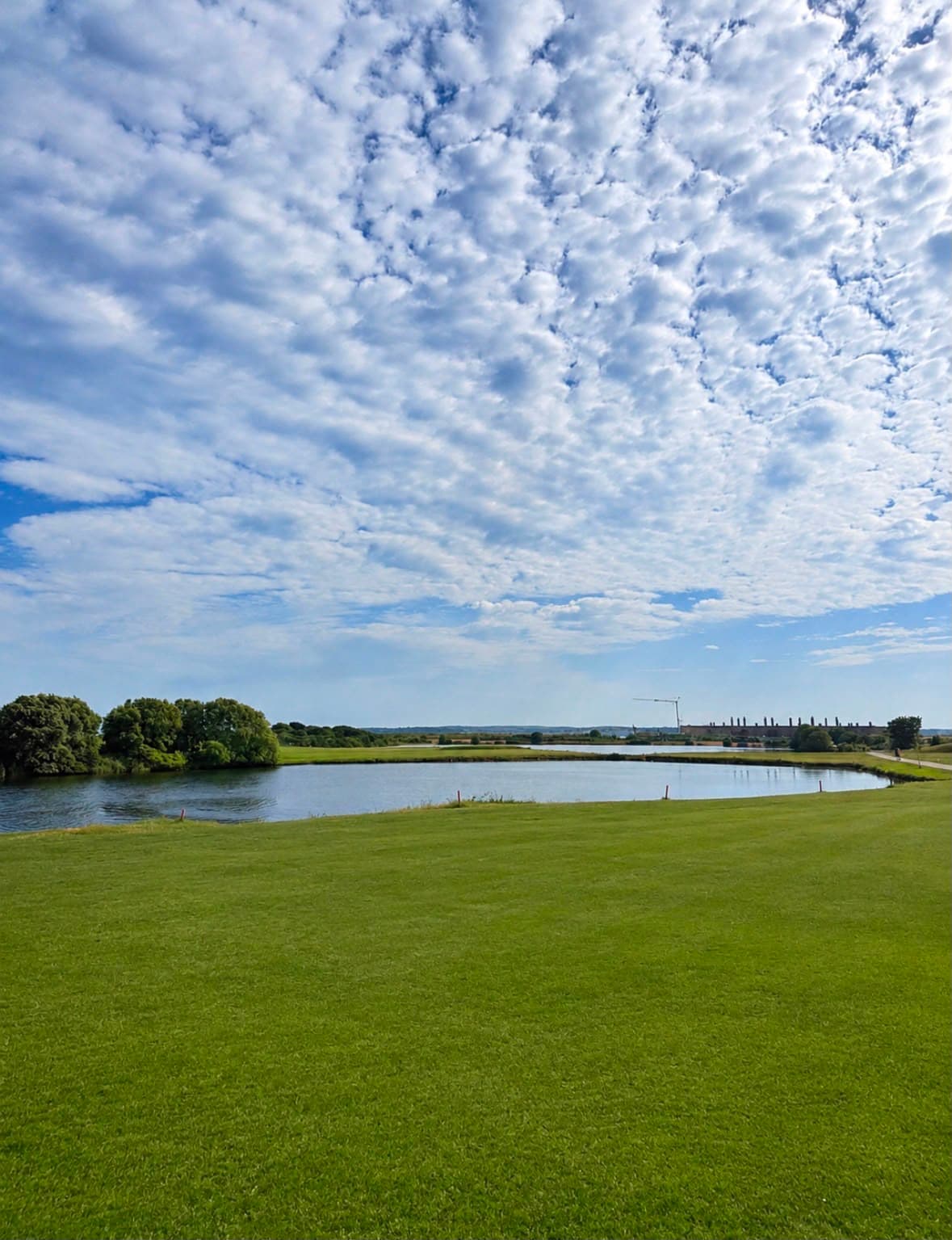 The course lakes — remnants of the old fort moats — under a moody sky